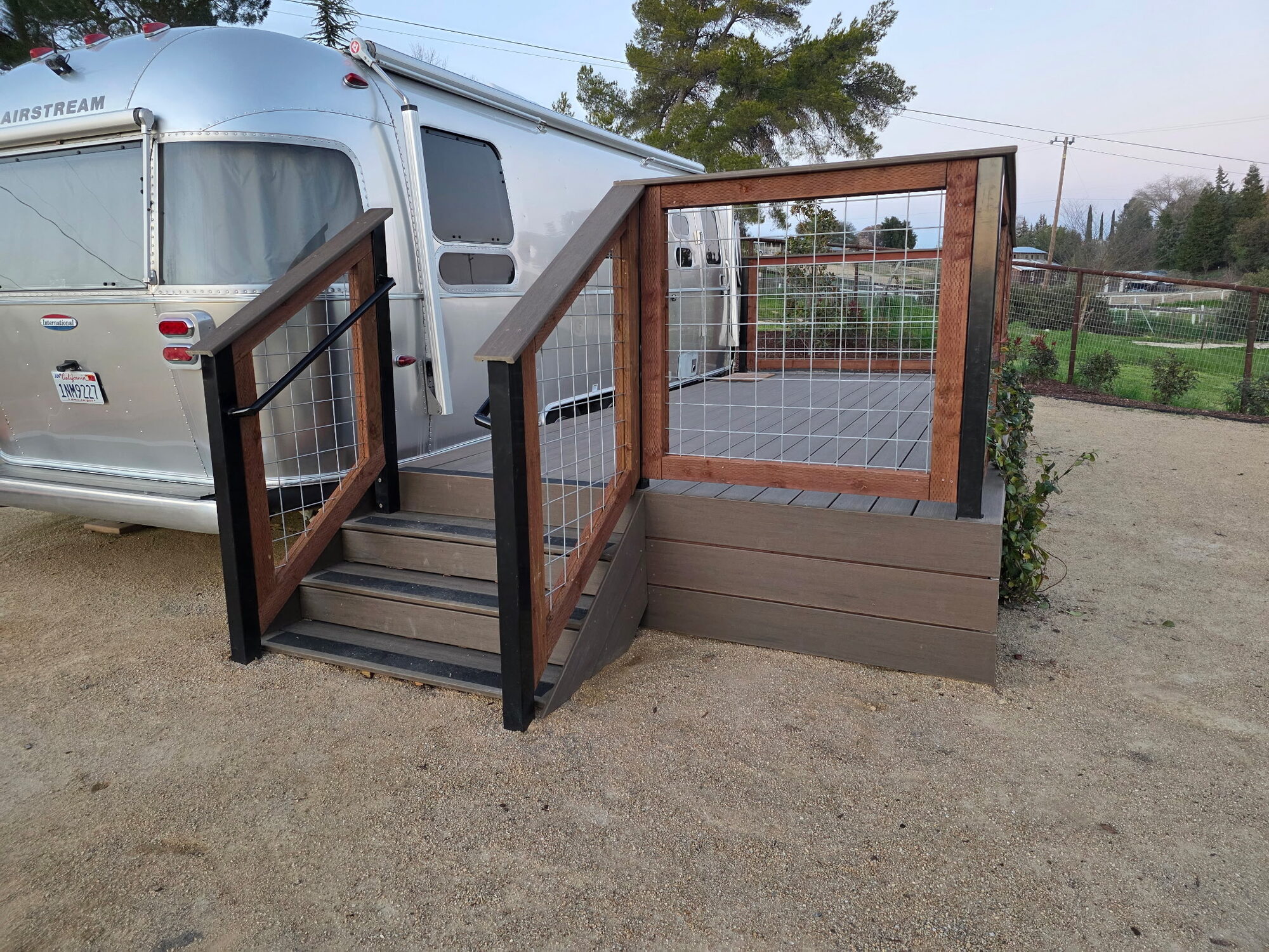 Custom deck and gate steps with wire mesh railing