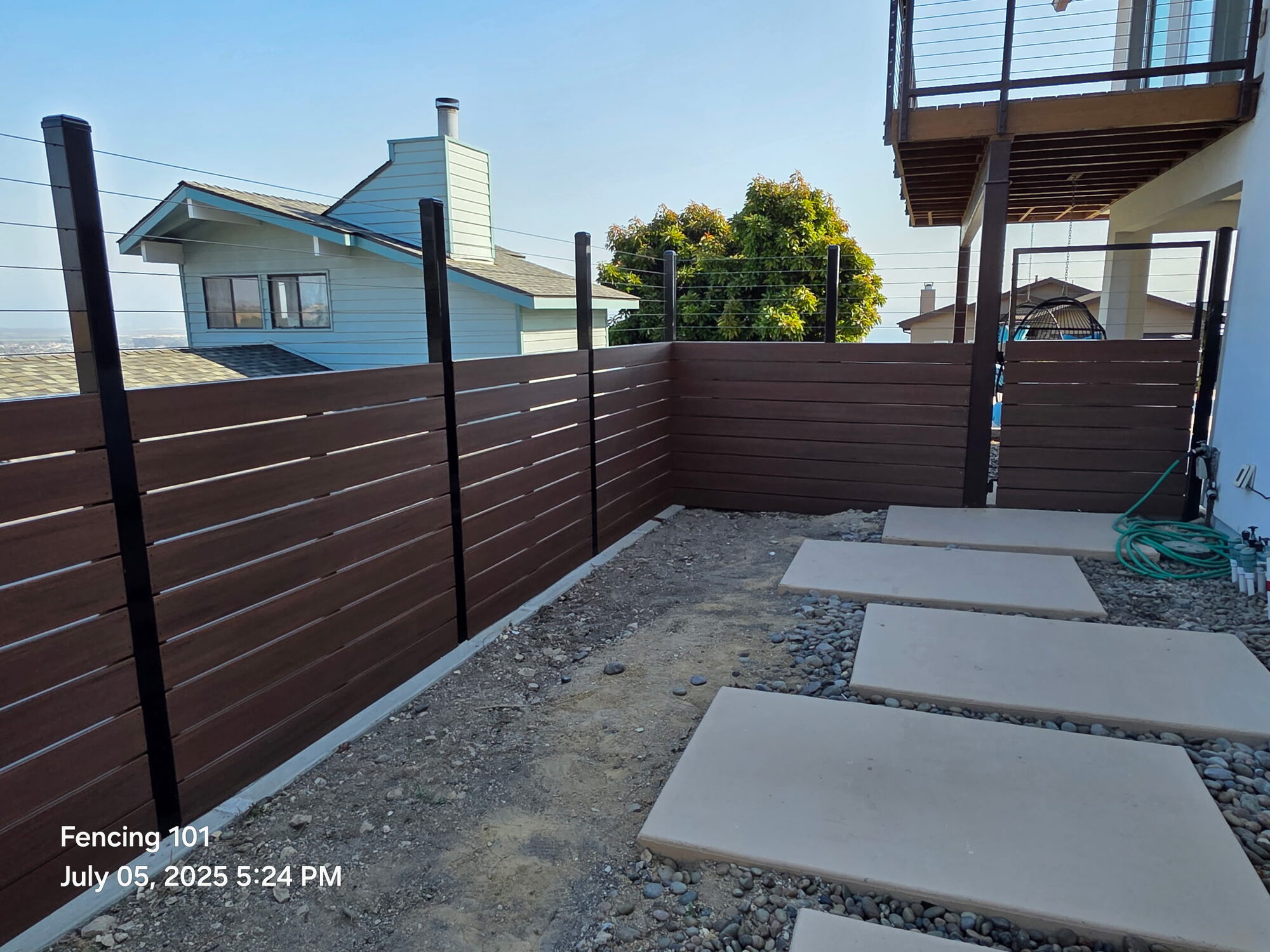 Horizontal wood slat privacy fence around a deck