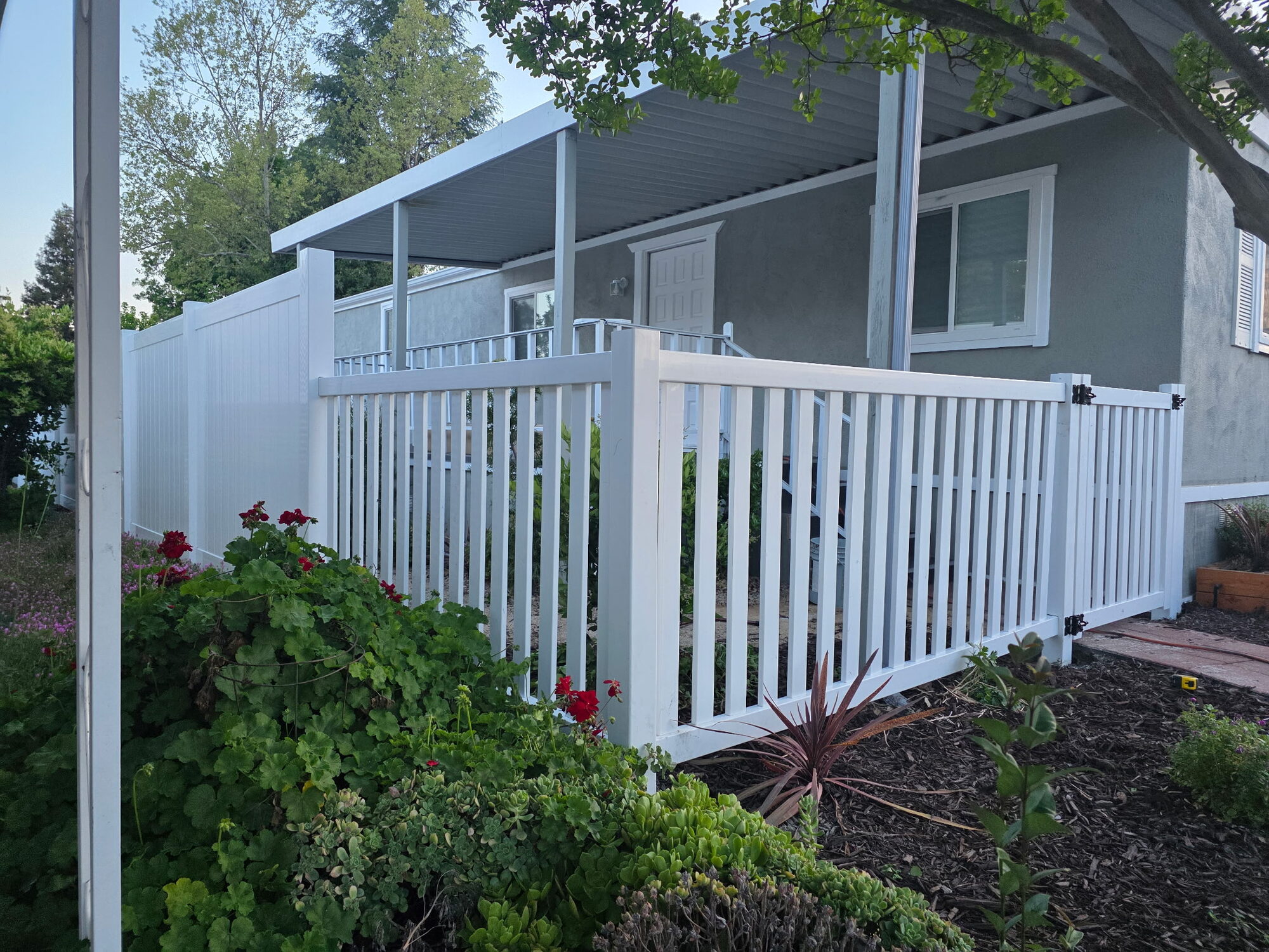 White vinyl fence under a patio cover